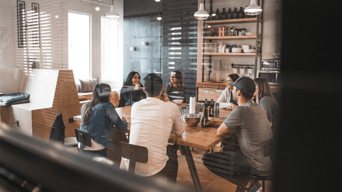 A group of people having a conversation in a modern style conference room. 