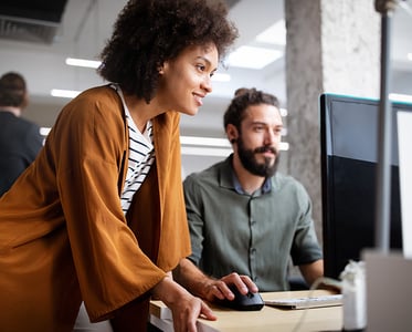 Coworkers looking at a monitor