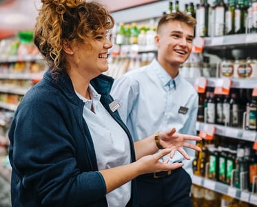 Supermarket manager walking with employee
