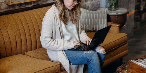 A person working on a computer reading about 401(k) plans.