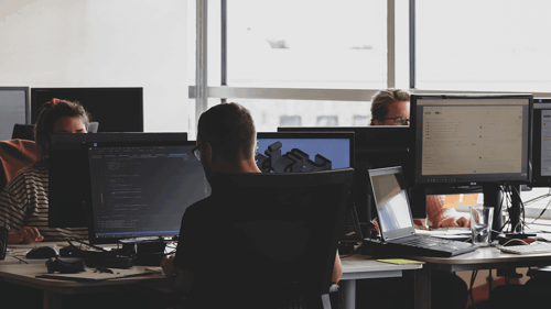 People working in a group work space on their computers