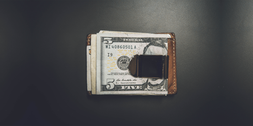 A wallet containing money, specifically the United States currency.