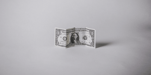 A single US Dollar bill that depicts a George Washington portrait