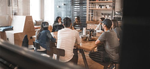 A group of people having a conversation in a modern style conference room. 