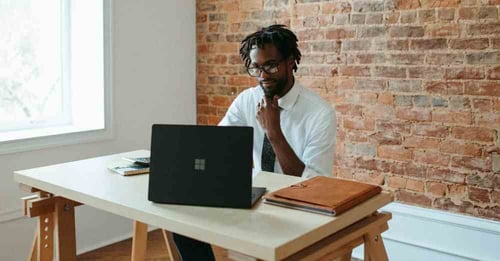 Businessman working hard at his desk, looking at this computer.