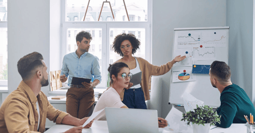 Employees engaged in a collaborative conversation during a work meeting