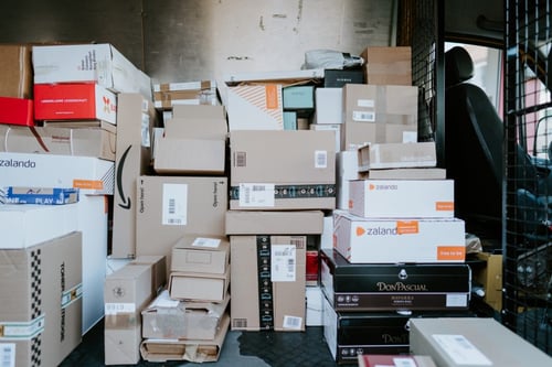 A stack of packages sits inside of a carrier truck