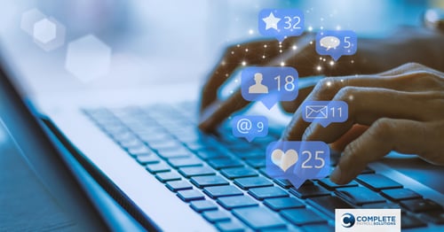A person types on their computer with social media counting graphics