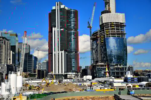 A cityscape with construction happening in the distance