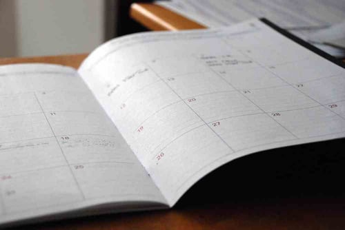 An open yearly planner sits open on a table