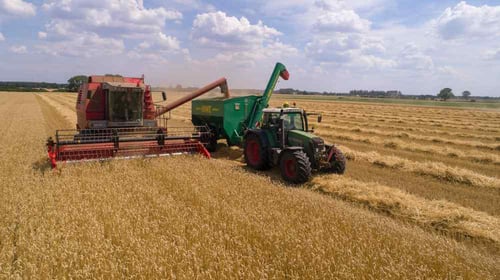 Farm equipment being driven through a field