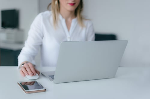 A person works at their laptop in a monochrom office