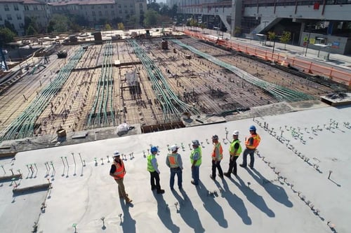 A group of construction workers look out on the job site