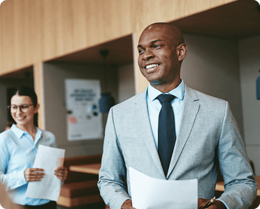Business coworkers holding forms and smiling