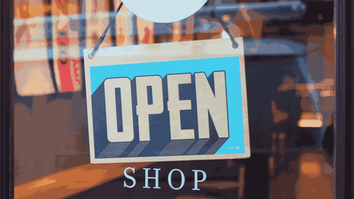 An open sign on a shop door.