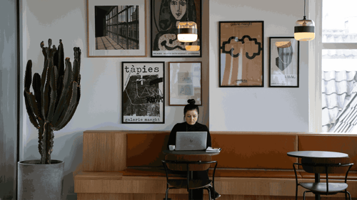A person sits working in a cafe. 