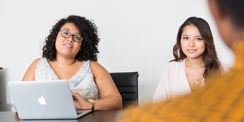 Two HR professionals going through the recruitment process.