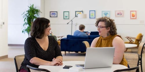 Two employees in a company going over the remote onboarding process.