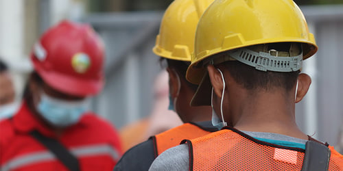 People in hardhats working.