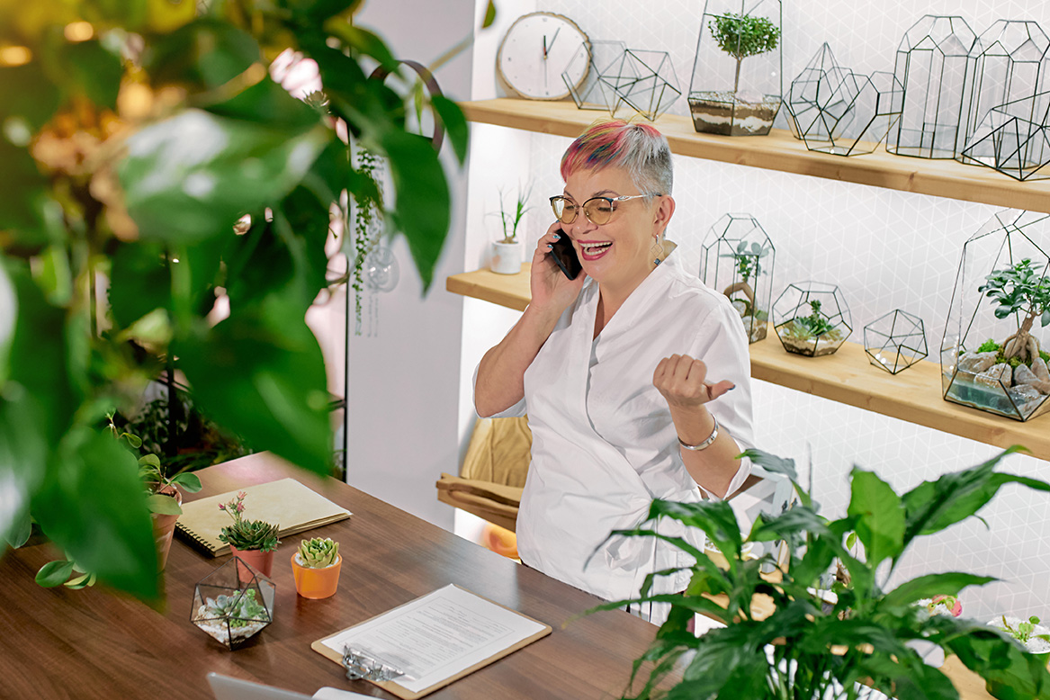 Trendy plant shop owner at check out counter