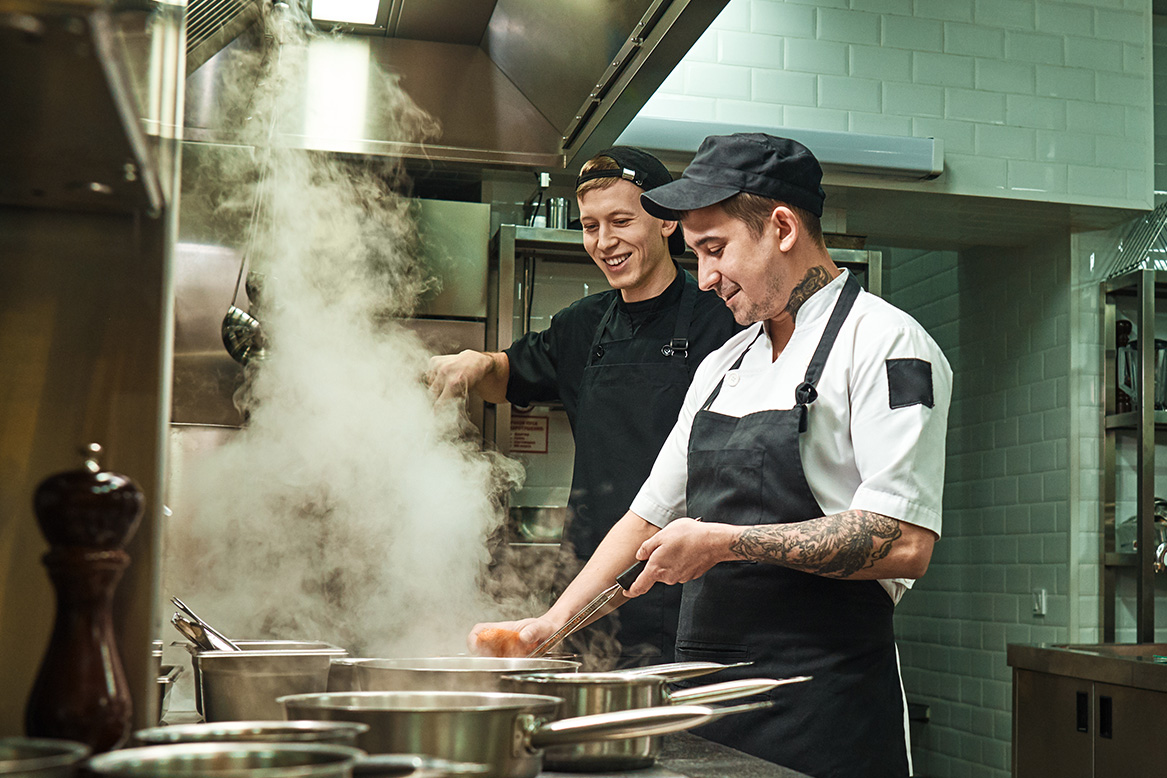 Chef and line cook testing a recipe together