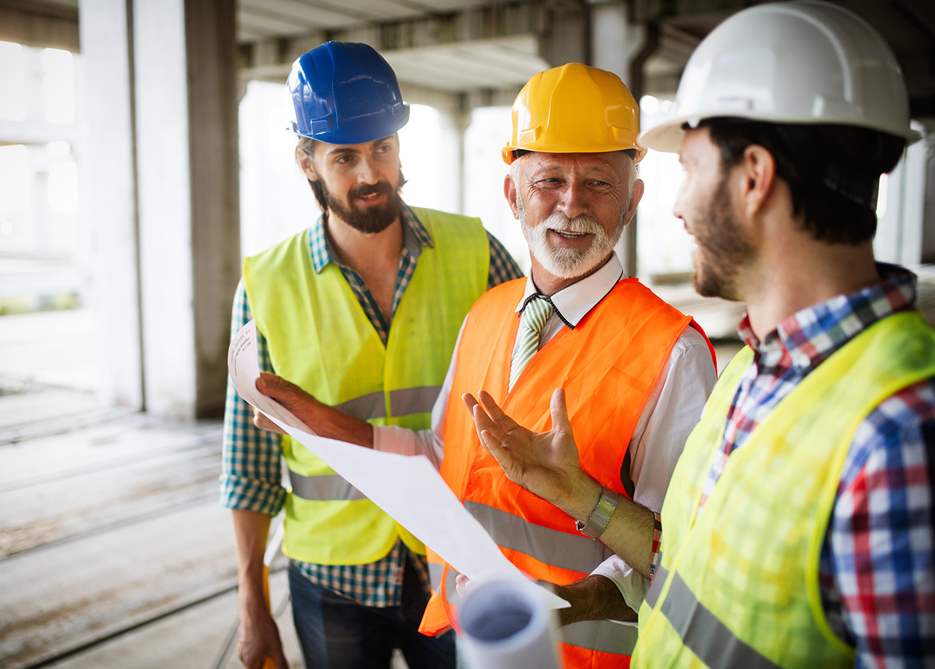 Construction workers reviewing building plans