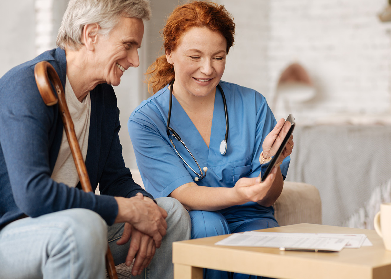 Home health care nurse reviewing paperwork with patient