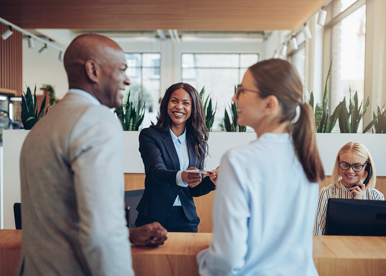 Friendly concierge with guests checking in