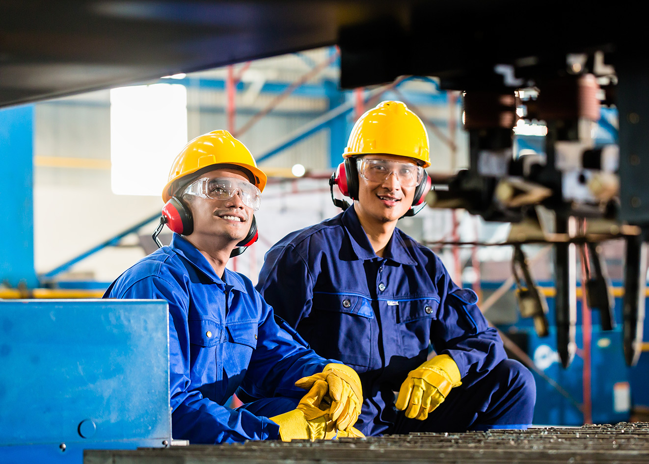 Manufacturing employees wearing safety gear at work