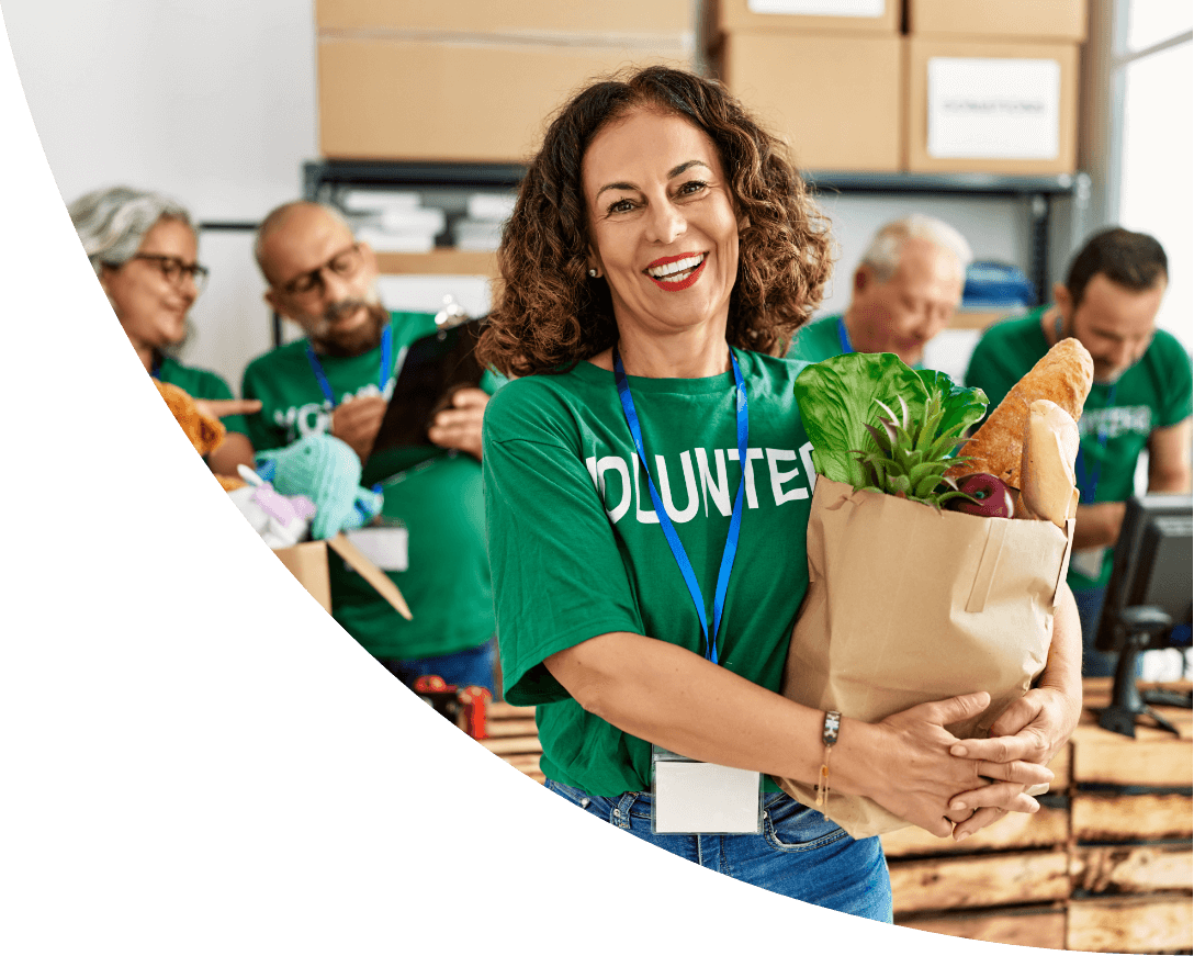 Happy volunteer holding a bag of groceries