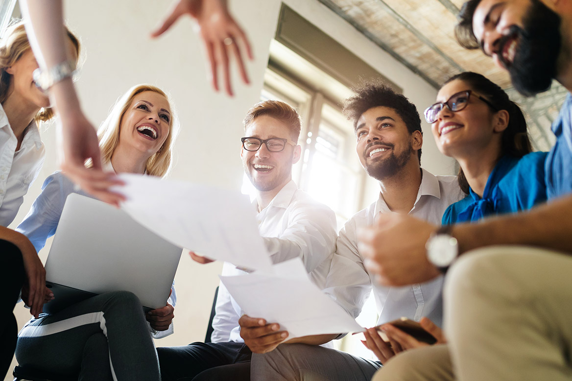 Employee huddle reviewing meeting notes