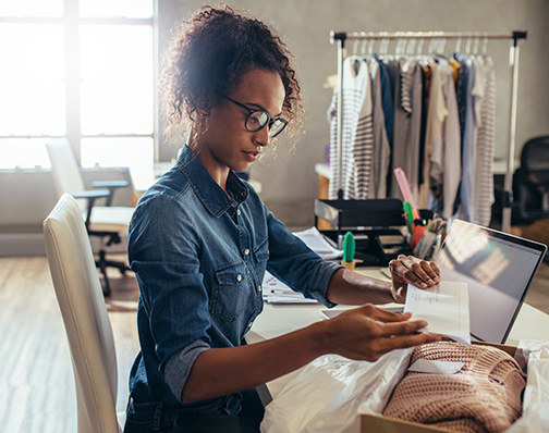 Boutique employee packing an online order