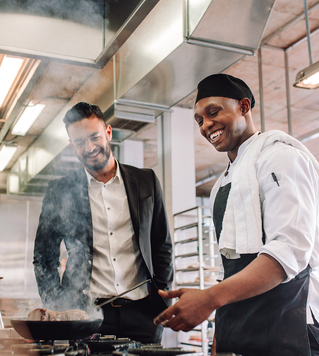 Cheerful restaurant owner and head chef in gourmet kitchen