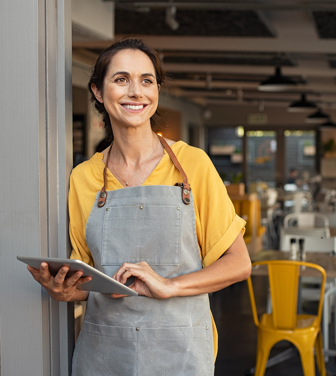 Cafe waitress holding an iPad at the entrance