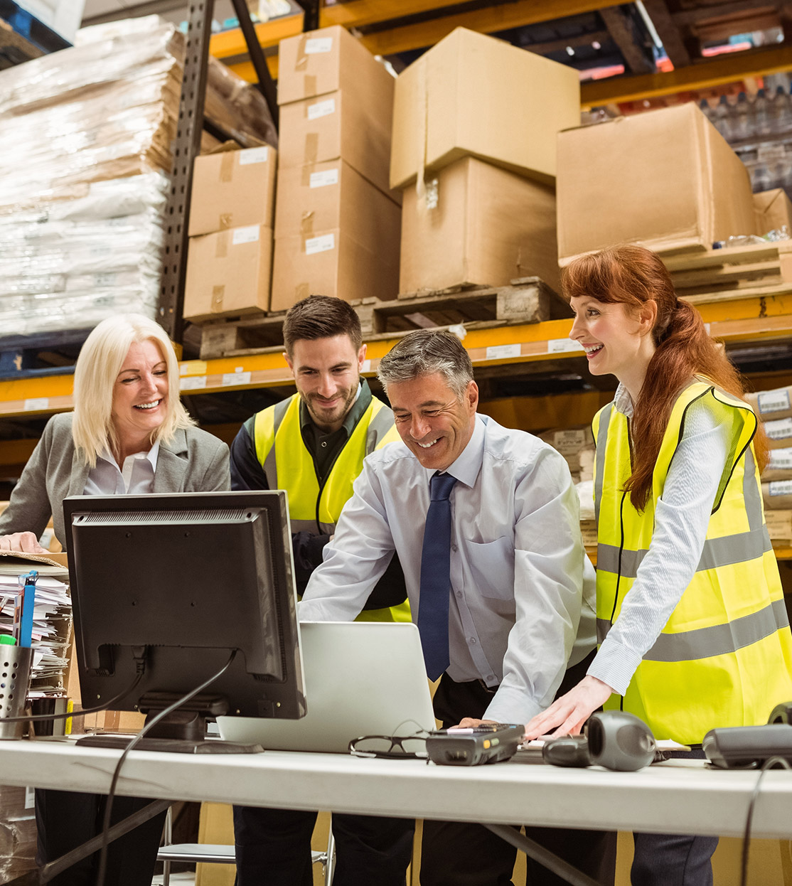 Warehouse staff reviewing inventory on computers