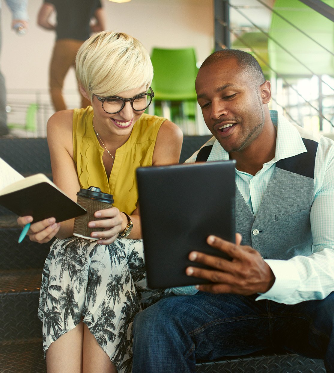 Startup founders reviewing notes on a tablet