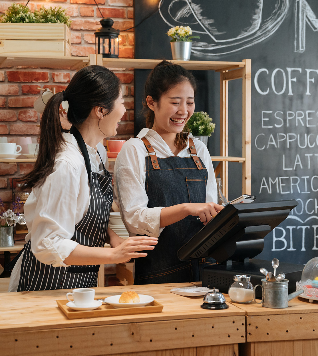 Baristas laughing at the counter