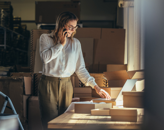 Startup owner on a phone call reviewing orders