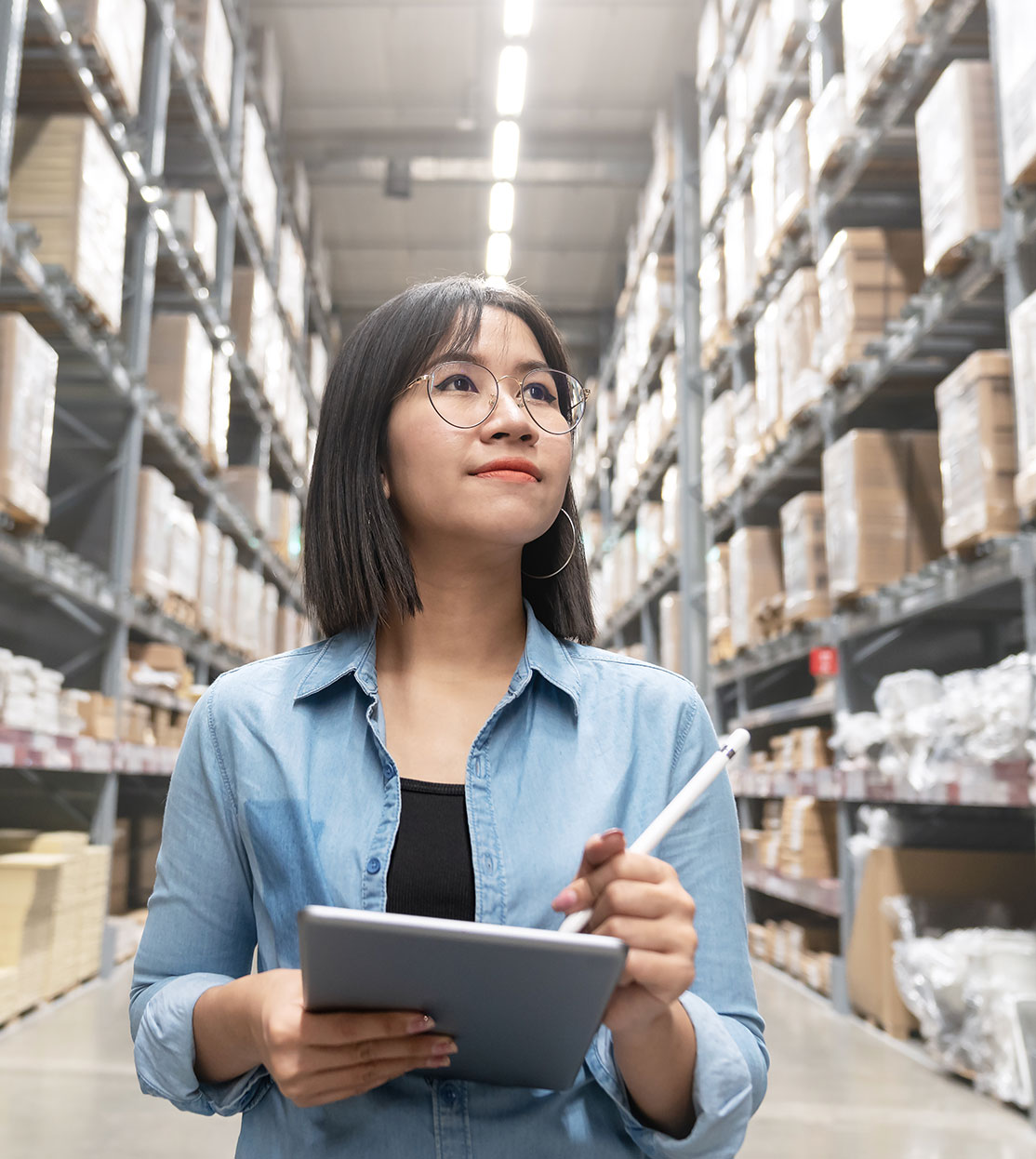 Business owner checking warehouse inventory on tablet