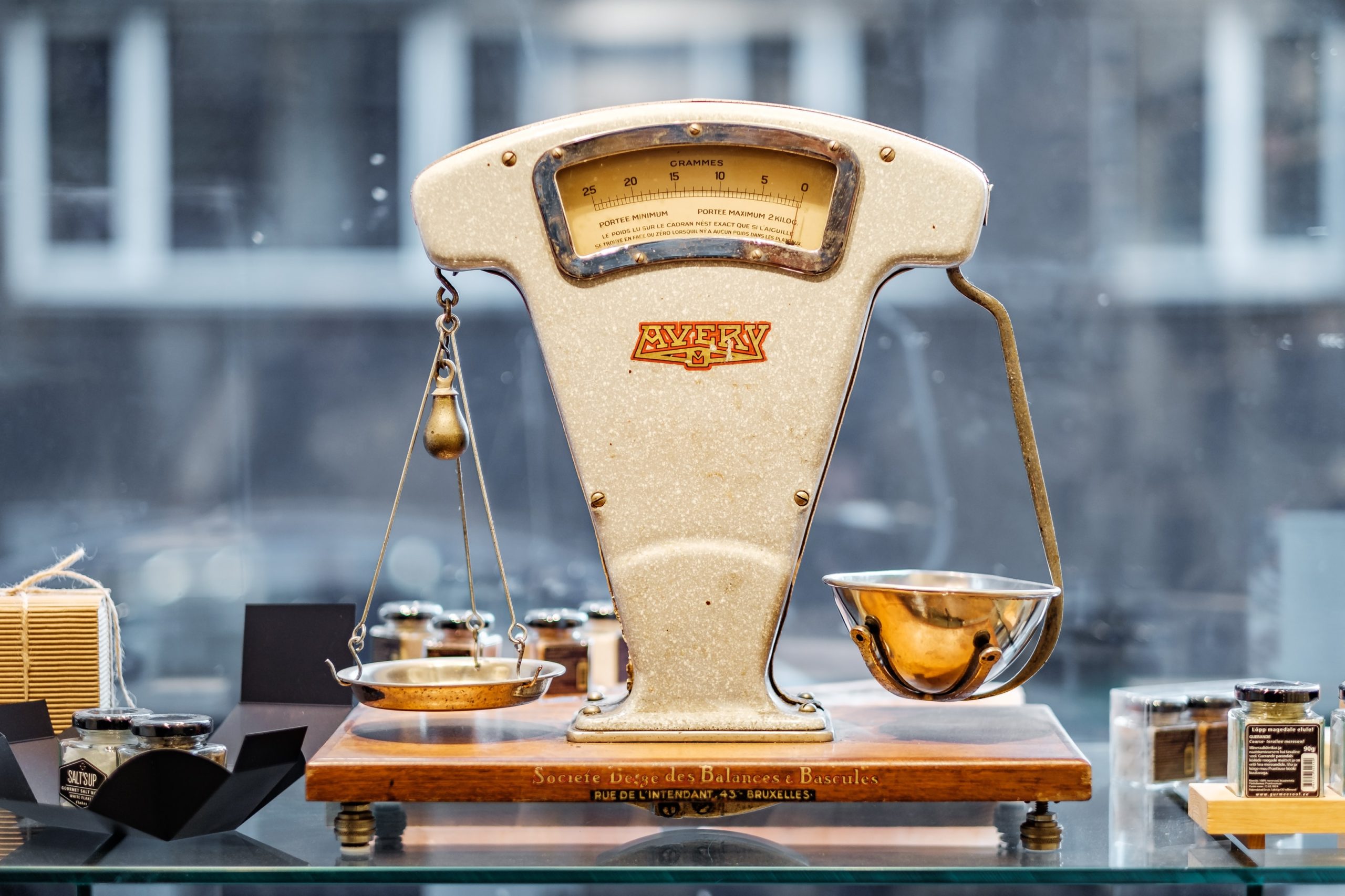 An old style scale rests on top of a table