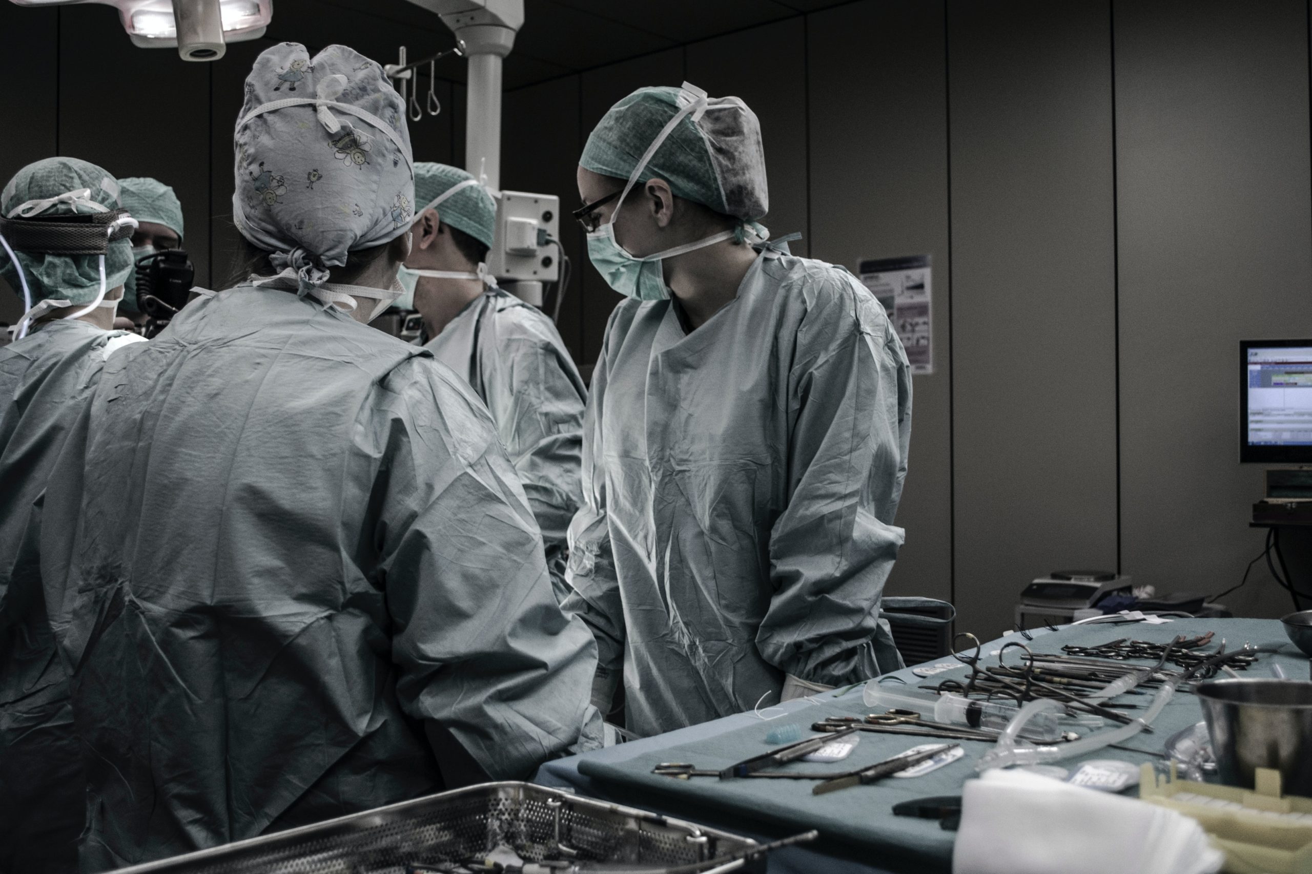 A group of medical professionals perform surgery
