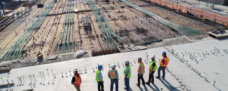 A group of construction workers is overlooking the construction site