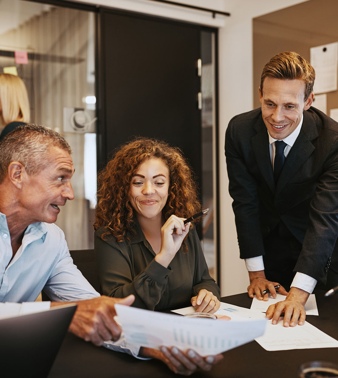 Business people discussing forms and smiling