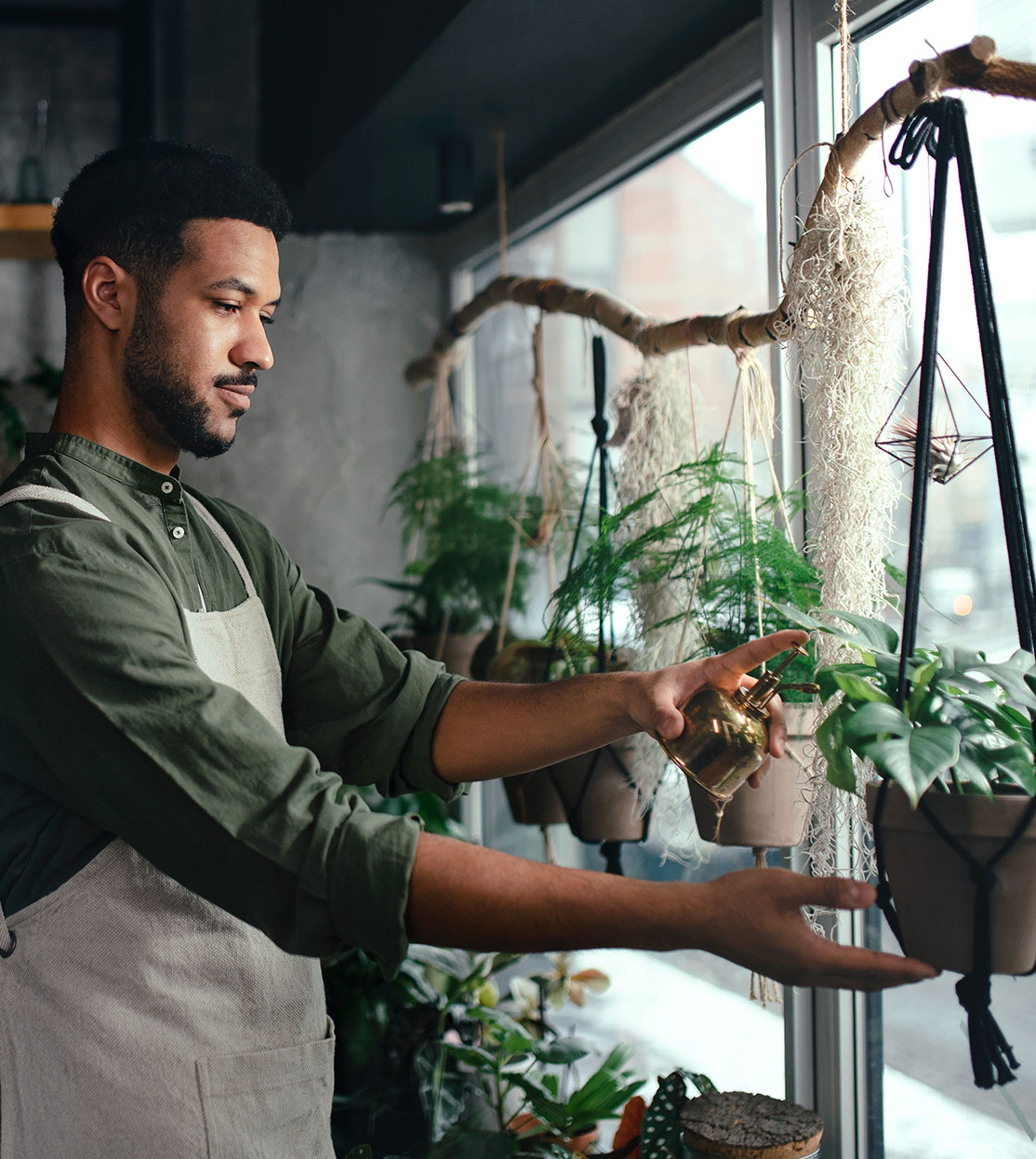 Small business owner adjusting plants